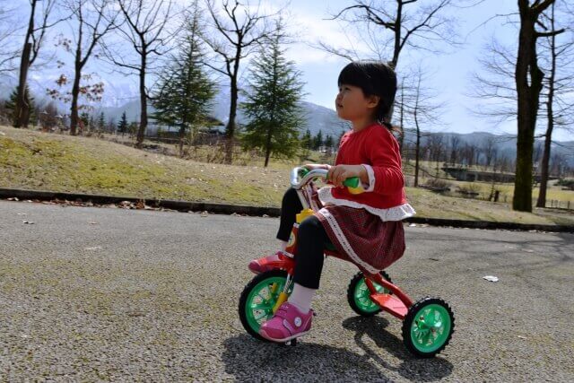 女の子が三輪車に乗っている様子