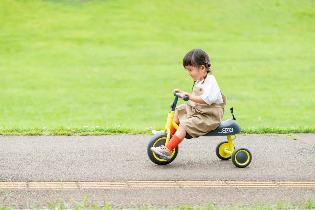 女の子が三輪車を漕いでいる様子